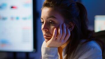Businesswoman who worked until midnight on project falling asleep in front of laptop in start up company office, resting on hand with closed eyes. Employee using technology network doing overtime photo