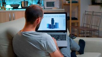 Architect using cad software to design industrial prototype drawing product shape working overtime from home. Tired freelancer looking at laptop computer display for new technical construction concept photo