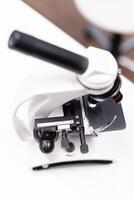 Medical microscope standing on table ready microbiology experiment in biochemistry pharmaceutical hospital laboratory. Chemical micro infection investigation. Biological expertise research photo