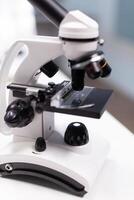 Dna molecular sample under microscope ready for biological virus vaccine investigation in biochemistry pharmaceutical hospital laboratory. Biological expertise research. Healthcare treatment photo