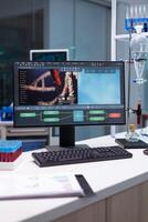 Computer standing on table with microbiology research on display during pharmaceutic biochemical experiment in biochemistry hospital laboratory. Biochemical researcher expertise photo