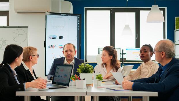 Multiethnical team talking with remote manager using call during virtual meeting sitting in startup financial business. Internet conference call technology talk with investors, corporate brainstorming via web photo