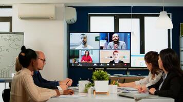 Team working by group call share ideas brainstorming negotiating use conference, pc screen view multi ethnic young people. Diverse people talking at virtual meeting, online discussion. photo