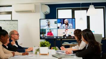 Headshot screen application view of remote multiracial employees talking on call brainstorm together multiethnic coworkers engaged in team discussion online using web conference, virtual meeting photo