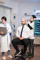 Women team neurological researchers working together developing treatment for diagnosis of brain disease, explaning eeg results, health status, brain functions, nervous system and tomography scan photo