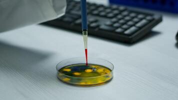 Close up of scientist using micropipette for analysing blood sample putting in petri dish. Team of researchers examining virus evolution using high tech for vaccine development against covid19 photo