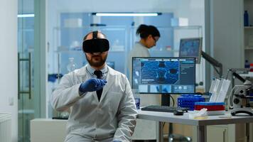 Professional scientist using medical inovation in lab wearing virtual reality glasses, gesticulating. Team of researchers working with equipment device, future, medicine, healthcare, vision, simulator photo