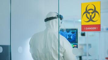 Team of chemist doctors wearing protection suit working in danger area of medical research laboratory. Scientist examining vaccine evolution using high tech for research in treatment for covid19 virus photo