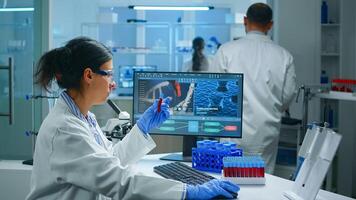 Group of scientists wearing lab coat working in laboratory while examining biochemistry sample in test tube and scientific instruments. Science technology research and development study concept photo