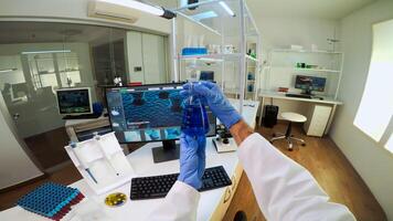 POV of medical scientist working with DNA scan image in modern equipped lab holding test tube with sample. Team examining vaccine evolution using high tech and chemistry tools for vaccine development photo