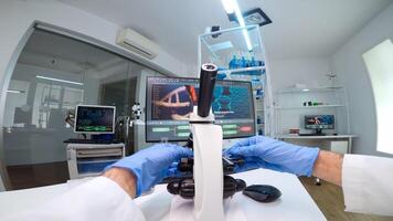 POV of scientists working in lab with patri dish looking into microscope blood analysis. Medical stuff examining vaccine development using high tech researching treatment against covid19 virus photo