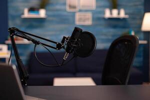 Empty podcast room with professional microphone in vlogger home studio in living. Influencer recording social media content with production microphone, digital web internet streaming station. photo