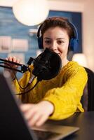Blogger speaking with followers on live podcast using headphones. Creative online show On-air production internet broadcast host streaming live content, recording digital social media communication. photo