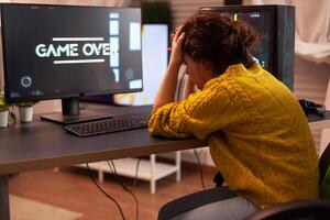 Angry pro gamer while playing shooter games beacuse she losing. Gamer over of mock-up videogame player, performing in stylish cyber room, virtual shooter game in cyberspace, pc gaming tournament. photo