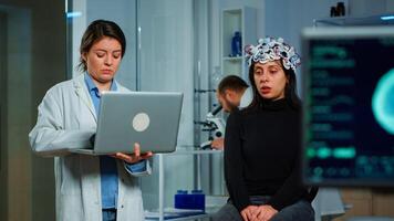 Team neurological doctors working together developing treatment for diagnosis of disease, explaning eeg results, health status, brain functions, nervous system and tomography scan. photo