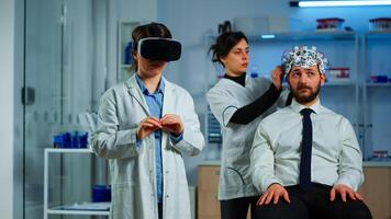 Advanced neurological scientist using medical inovation in lab wearing virtual reality glasses, gesticulating. Team of researchers working with equipment device, future, medicine, healthcare, vision, simulator photo