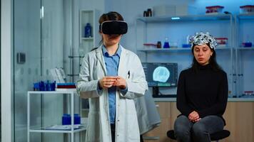 Laboratory doctor experiencing virtual reality using vr goggles in medical neurological research lab. Physician therapist using medical innovation equipment device glasses, analysing brain scan photo
