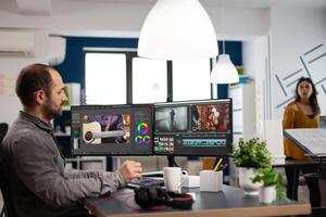 editor man editing movie project working in start up creativity multimedia agency office sitting at pc with two monitors. Editor processing film montage using post production software photo