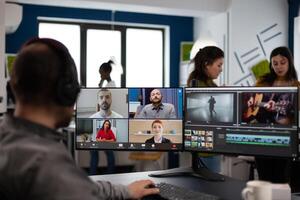 Senior editor director talking with creative team in web online meeting on call editing client footage work. Man getting feedback on movie using post production software on pc photo