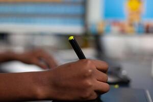 Close up of black designer editing customer client image with stylus pencil, drawing on graphics tablet. Hand of african american woman editor photographer retouching assets working in creative production company office photo