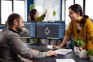 Coworkers engineer working on modern cad program developing industrial metallic construction. Architects designer studying prototype idea on pc showing digital company software with gears photo