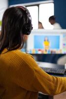Creative photographer editor retouching photos of a client on performance PC with two displays setup. Woman retoucher working in editing software app sitting office holding stylus pen