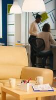 Diverse business people working in modern start up office discussing financial strategy. Multiethnic coworkers talking about startup annual reports of company in modern business office photo