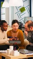 Black Businesswomen shaking hands with manager sitting on couch during business meeting. Diverse business people planning partnership deal discussing project steps for new start-up company. photo