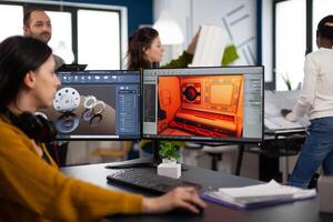 Engineer developer analyzing cad software to develop creative game, working in startup gaming company for prototype. Design technician studying on computer developing new online games photo