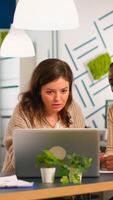 Creative diverse businesswomen meeting in modern company office working over computer screen on combined teamwork project. Multi ethnic group of people working together for startup business photo