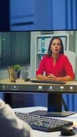 Manager woman talking with coworker during conference at midnight from business office planning financial strategy. Lady using modern technology network wireless discussing at virtual meeting photo