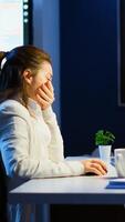 Tired designer engineer analizing new prototype of 3D model of the plant yawning working overtime. Industrial female worker studying turbine idea on pc showing cad software on device display photo