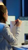Engineer constructor designer architect creating new component in CAD program working in business office. Industrial woman employee studying prototype idea showing cad software on device display photo
