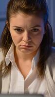 Close up of exhausted manager working overtime to respect deadline of project sitting in business office typing on laptop late at night. Focused employee using modern technology network wireless photo
