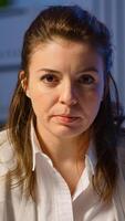 Portrait of employee having conference late at night overworking sitting in modern start-up office drinking coffee. Freelancer talking on virtual meeting at midnight doing overtime photo