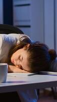 Exhausted overload business woman falling asleep on desk with open laptop monitor while working in start up company office. Employee using modern technology network wireless doing overtime sleeping photo