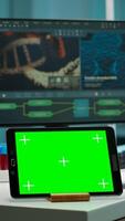 Display tablet with green screen, mock up on template placed on desk in scientific laboratory while woman medical research scientist analysing virus evolution at digital monitor conducting experiment photo