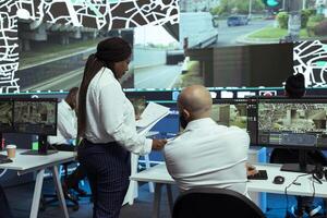 African american manager provides essential awb and receipt for logistics work, proceeding with order tracking on satellite navigation. Supervisor overseeing cargo transportation activity. photo