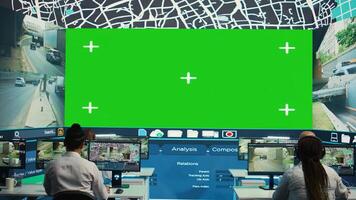 Group of employees monitoring delivery trucks routes with an isolated screen, working with satellite map and radar. Diverse people look at greenscreen display, order tracking. Camera B. photo