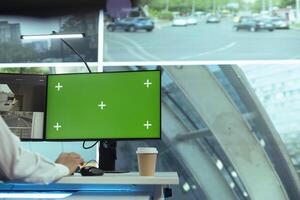 Employee uses CCTV camera recording and a mockup screen in monitoring room, following traffic activity and checking radar information for public safety. Radar surveillance system. photo