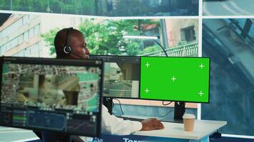 African american agency worker using CCTV footage and isolated display, monitoring traffic through real time surveillance in observation room. Employee works within the government. Camera A. photo
