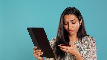 Woman trying to do purchases, frustrated with error received while adding payment method on website, studio background. Upset person unable to do internet shopping, getting card rejected, camera B photo