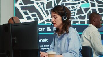 Woman call center operator transmitting directions through traffic after monitoring surveillance radar system at stop lights. Employee working on order tracking and express delivery. Camera A. photo