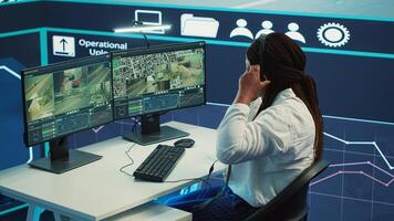 African american employee tracking orders on satellite navigation with gps coordinates, looking for routes to help couriers with express shipping service. Agency worker in control center. Camera A. photo