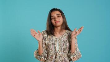 Lazy woman lacking interest for anything, feeling depressed, looking lifeless, isolated over studio background. Portrait of bored indian person suffering from tiredness, feeling exhausted, camera A photo