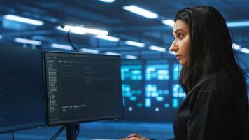 Meticulous engineer inspecting operational server rows in computer network security data center. Woman supervising supercomputers providing processing and memory resources for various workloads photo