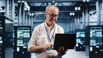Overseeing supervisor expertly managing data while navigating in industrial server room. Skilled manager in high tech facility ensuring optimal cybersecurity protection, optimizing systems photo