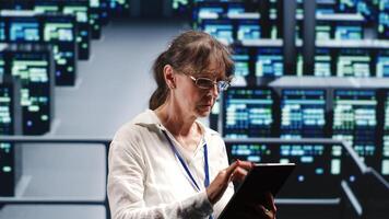 Experienced manager in high tech workplace equipped to handle modern computing requirements, doing regular upgrades to server rows, increasing processing power and storage capacity to prevent bugs photo