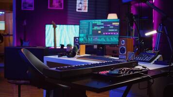 Empty home studio used for recording and mixing music with electronic modern equipment, creating soundtracks with control panel soundboard and mixer console. Signal processing. Camera B. photo