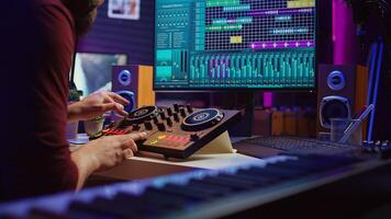 Audio engineer recording piano keyboard instrument notes and vocals, operating a mixing console with amplifier and daw software on computer. Artist editing sounds for music industry. Camera B. photo